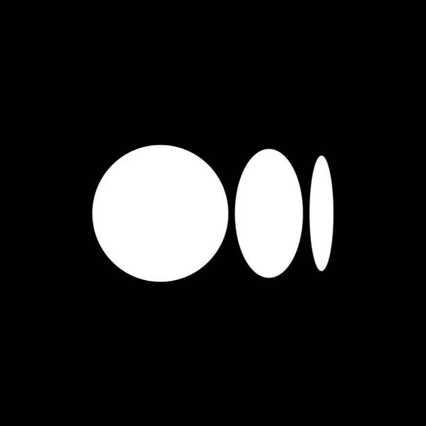 Three white oval shapes decreasing in size from left to right on a black background.
