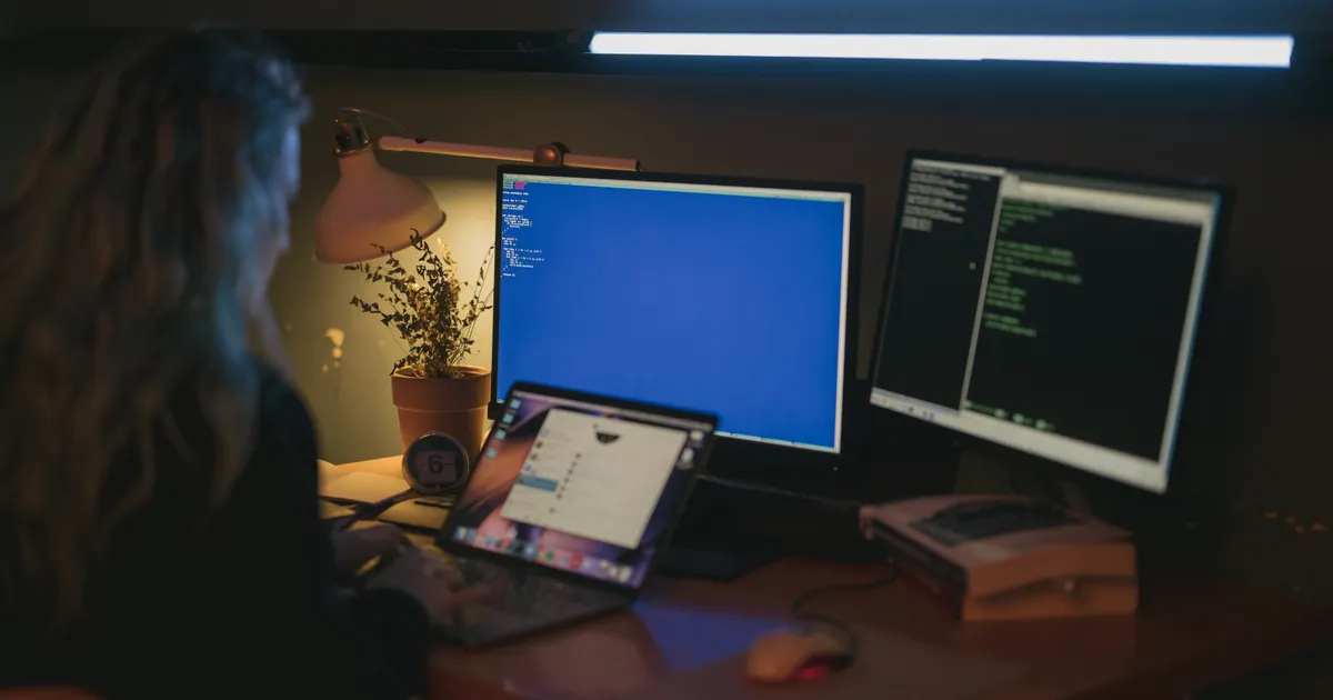 A desk workspace with several screens and devices showing different browser windows