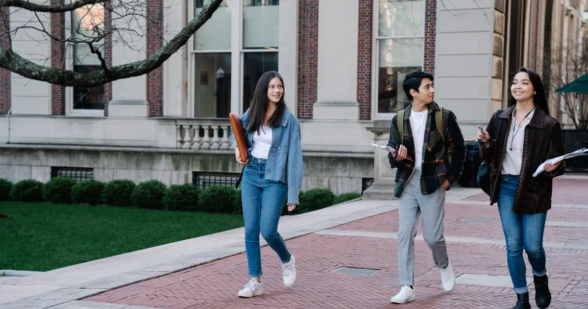 University students walking together across a campus courtyard