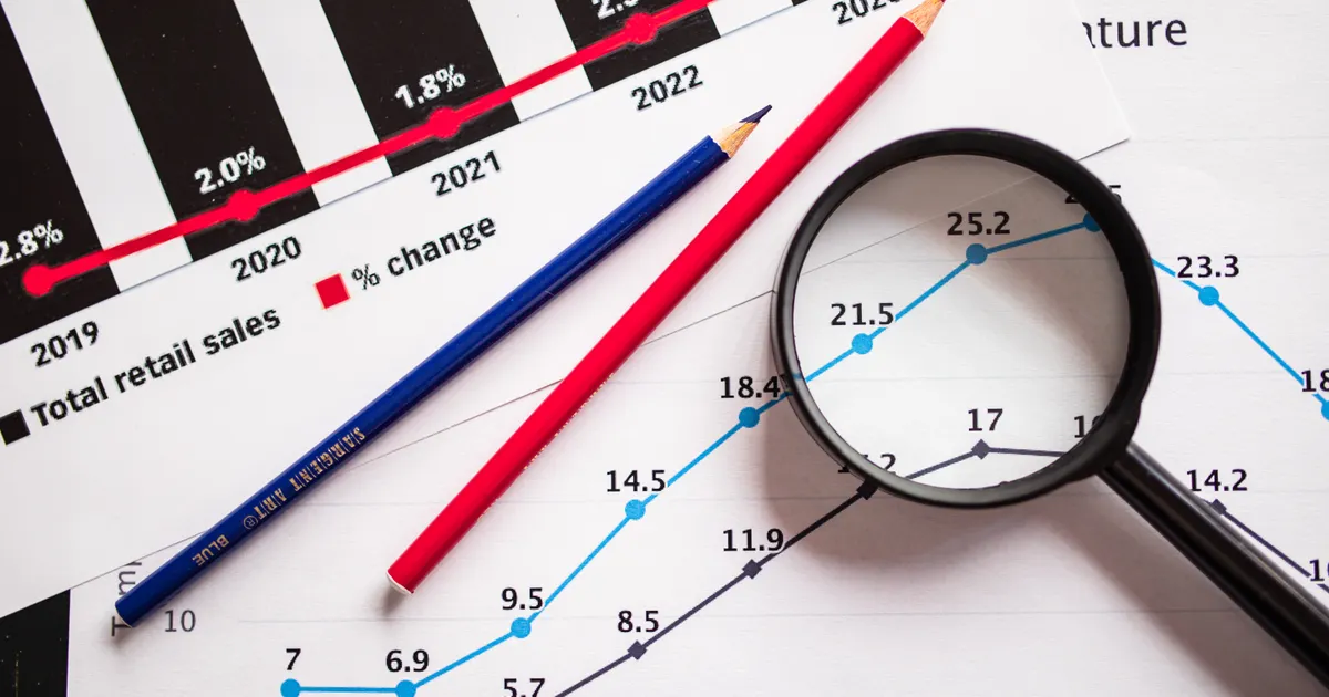 A printed business analytics report showing growth charts on a desk
