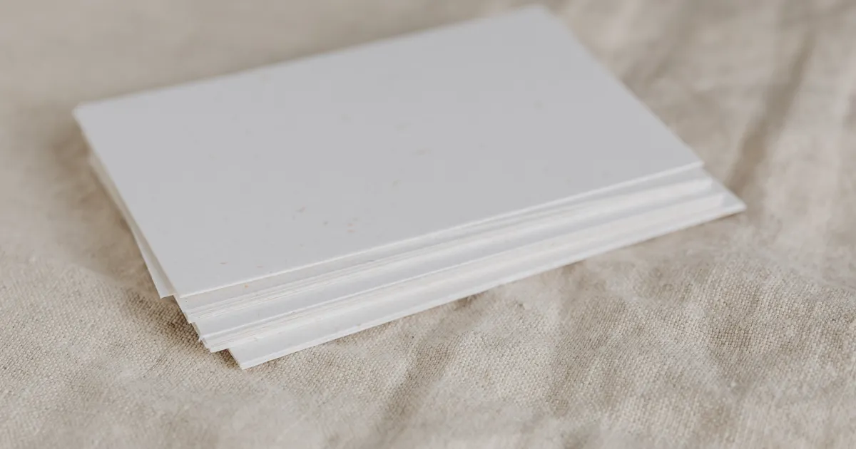 A stack of printed document pages on a wooden desk