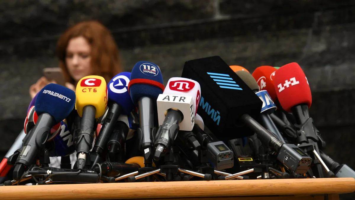 Row of microphones set up for a press conference, illustrating the ranking of the best PR agencies in France
