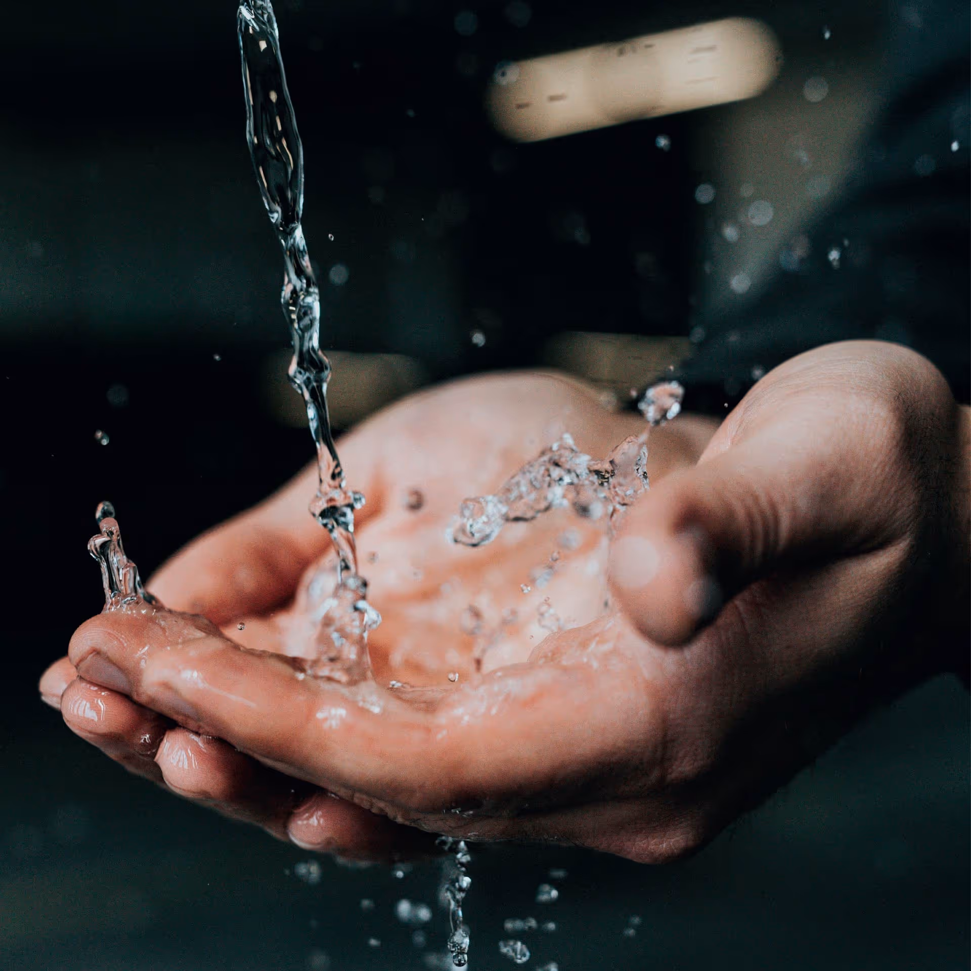 Hands collecting water