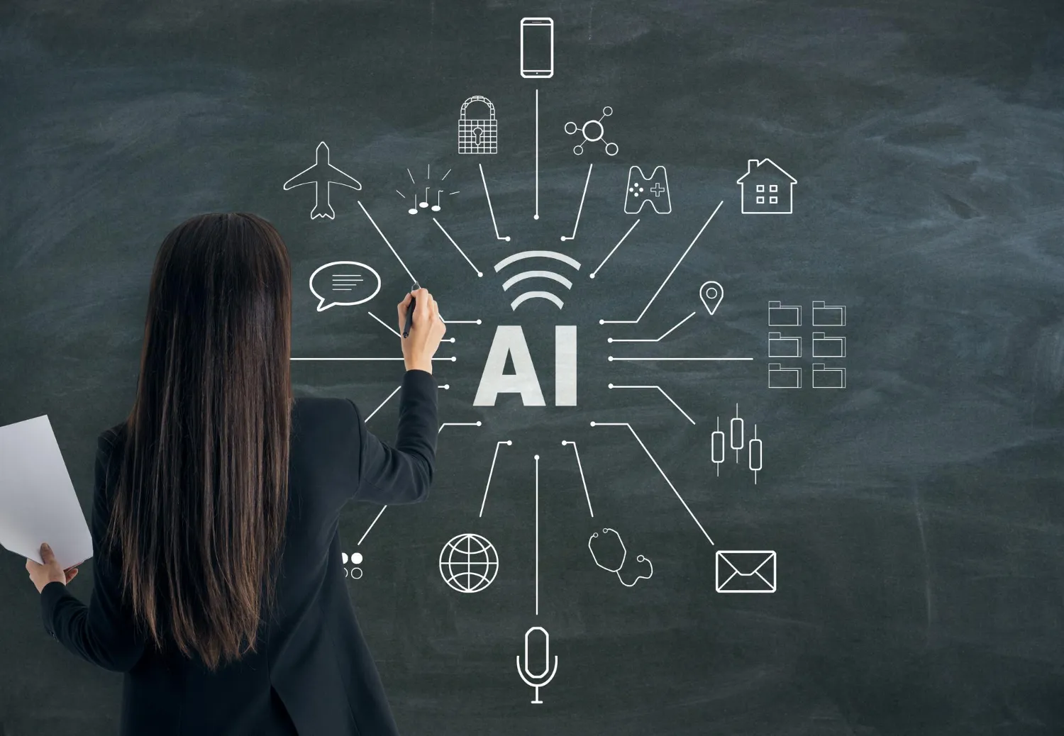 Woman in a black blazer writing on a chalkboard with AI and connected icons like airplane, lock, music notes, game controller, house, and envelope.