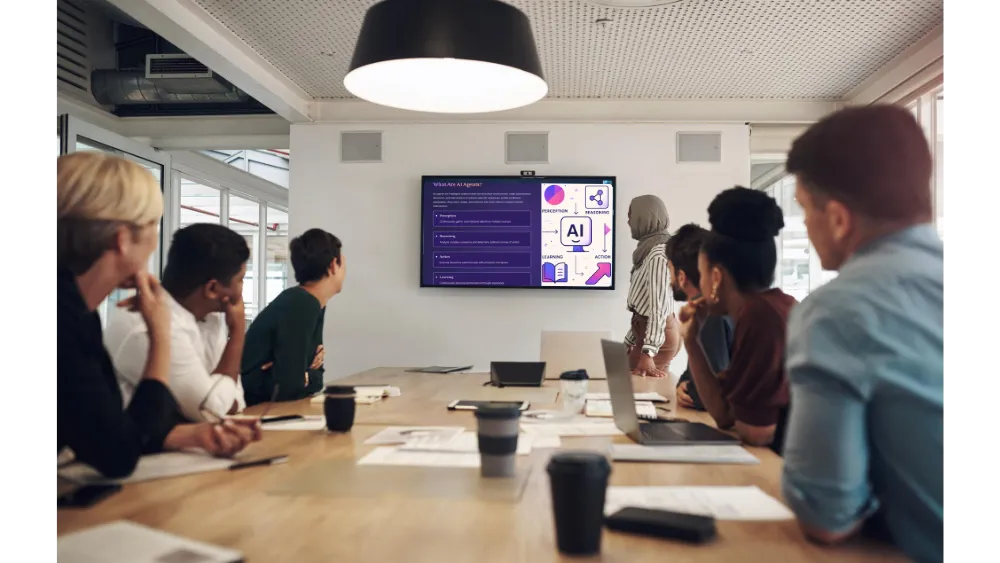 A diverse group of people in a meeting room watching a presentation about AI algorithms displayed on a wall-mounted screen.