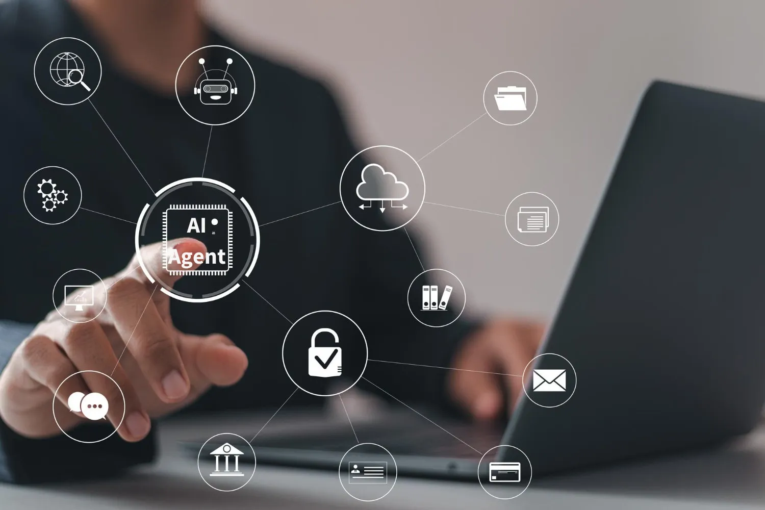 Hand pointing at virtual interface with AI agent icon connected to cloud, lock, robot, email, and other technology icons over laptop keyboard.