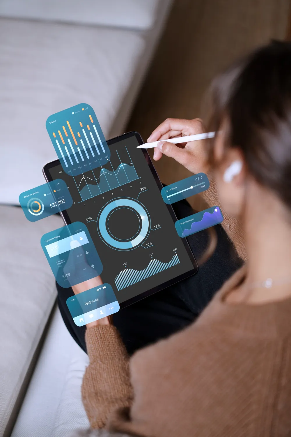 Person using a stylus on a tablet displaying digital financial charts and graphs with augmented reality data overlays.