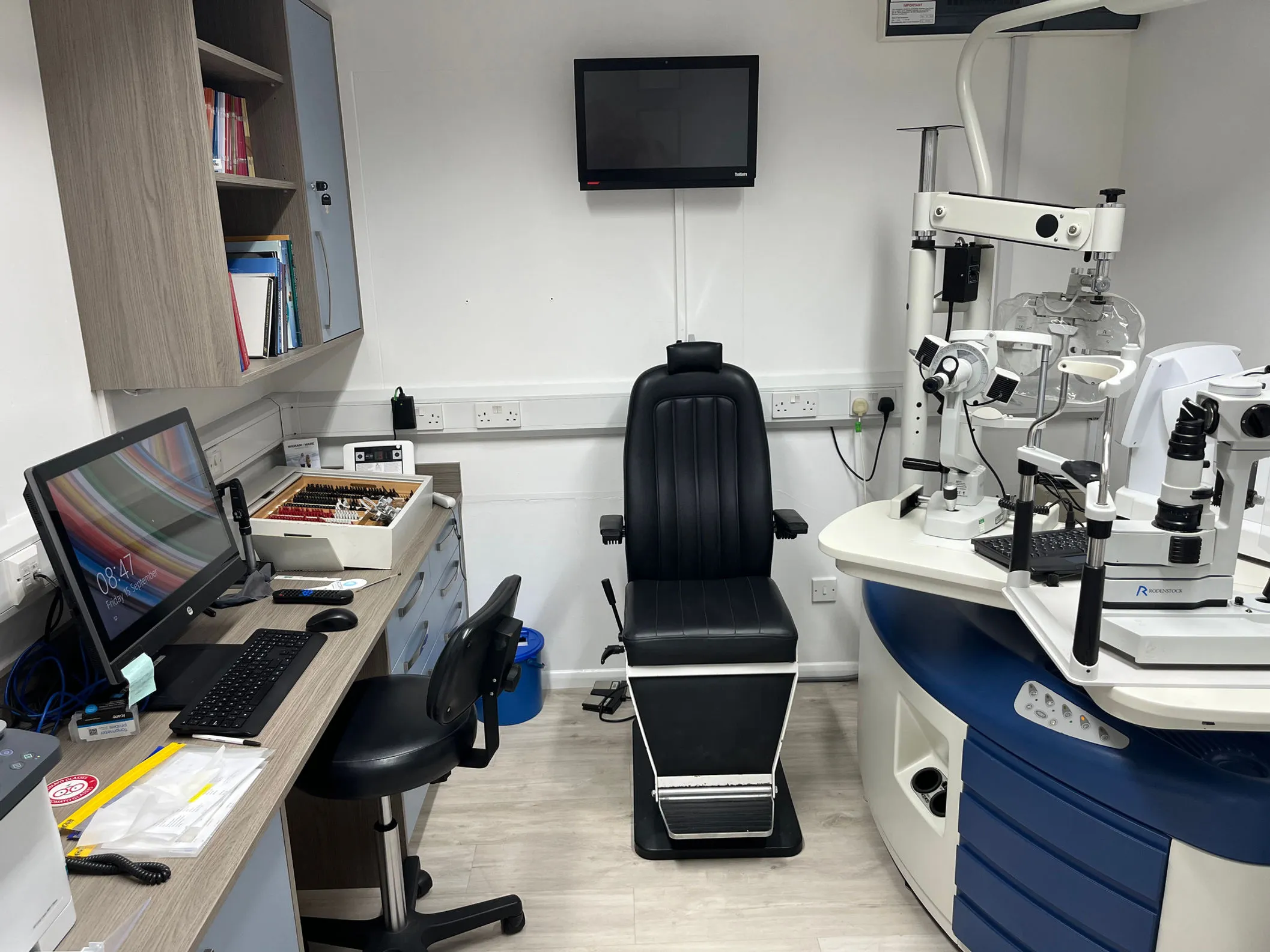 Optometrist office with eye examination equipment and computer workstation