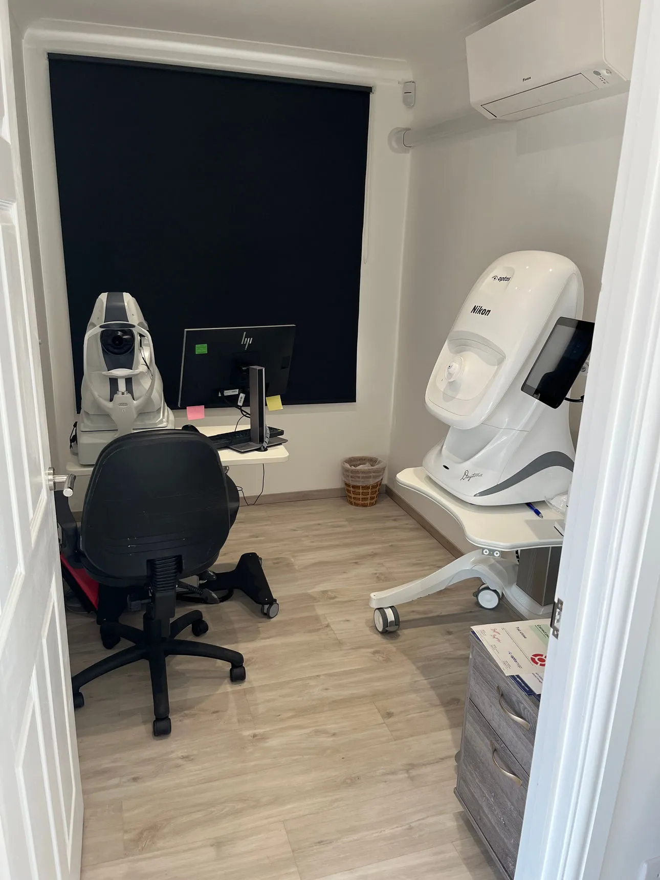 Eye examination room with medical equipment and computer workstation