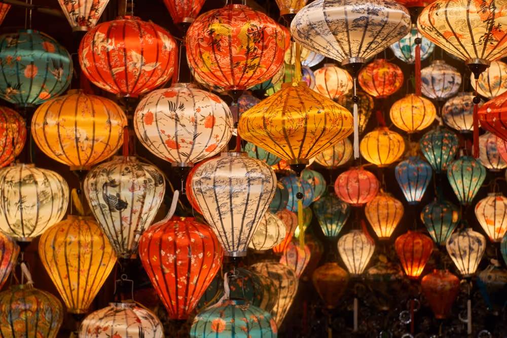 Chinese silk lanterns of many colours hanging from the ceiling of a shop