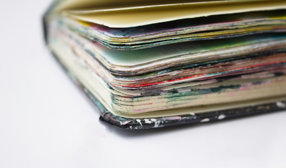 Close up image of the corner of a used art sketchbook