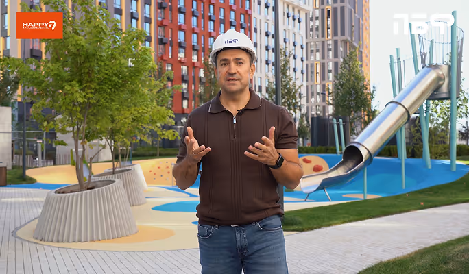 A man standing in front of a playground.