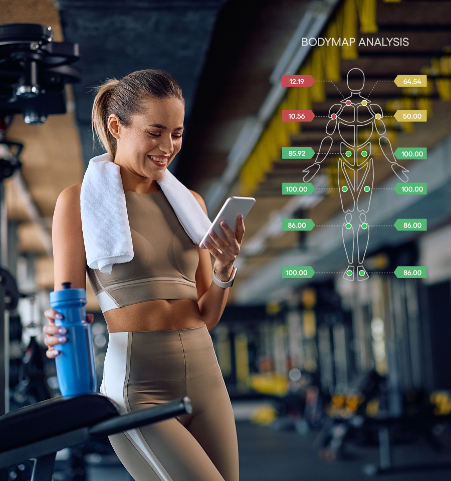 Smiling woman in workout clothes at gym holding blue water bottle and phone, with body map analysis graphic overlay showing fitness data.
