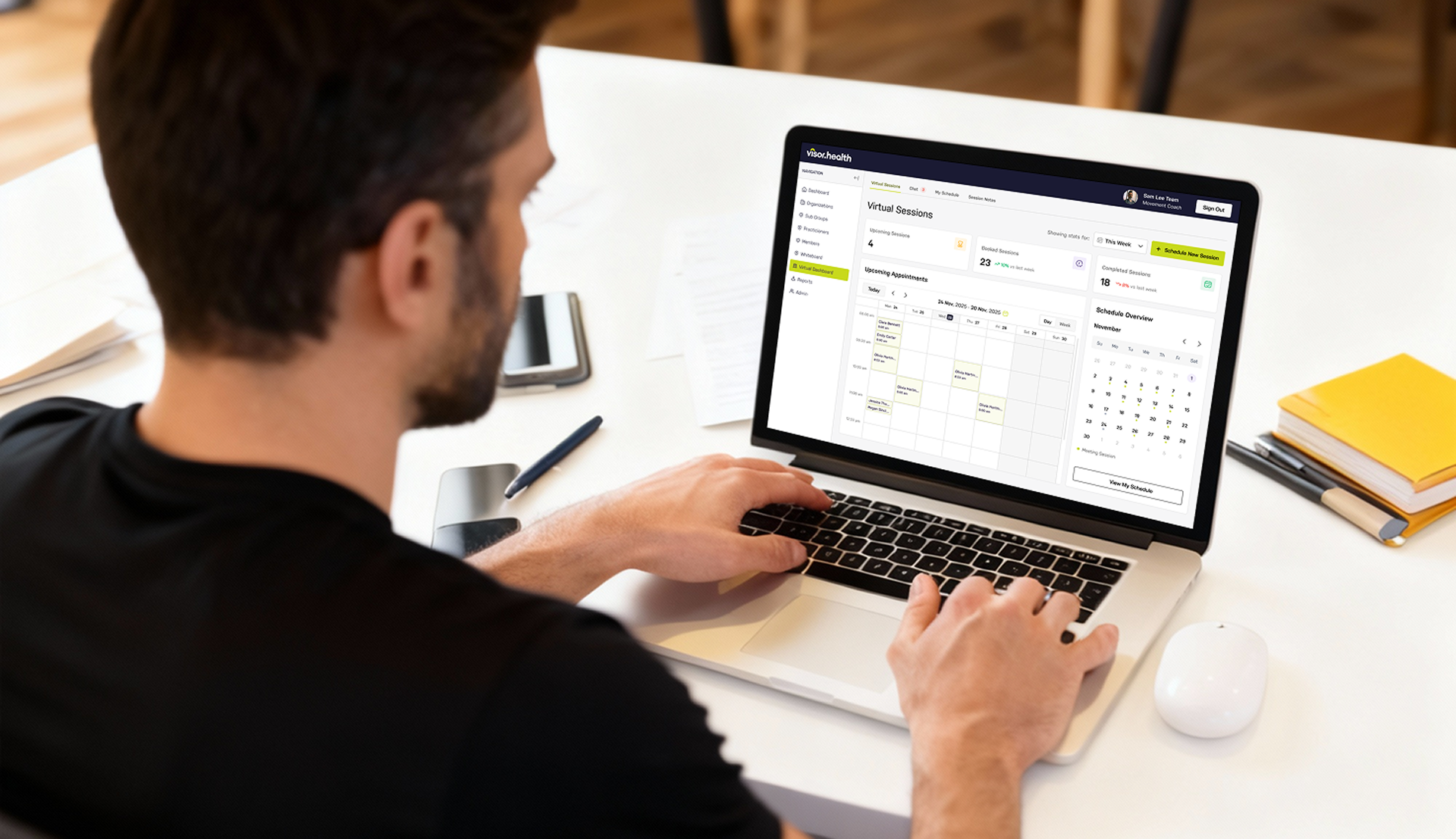 Man using a laptop with a virtual sessions calendar and schedule overview on the screen.