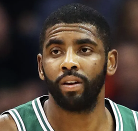 Close-up of a male basketball player with a beard wearing a green and white jersey.