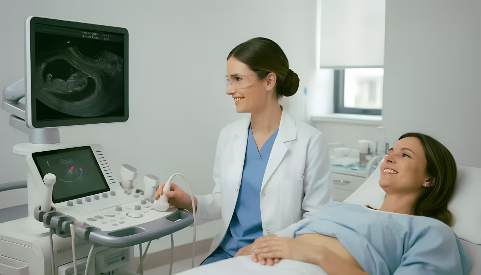 Smiling doctor performing an ultrasound scan on a pregnant woman lying on a hospital bed.