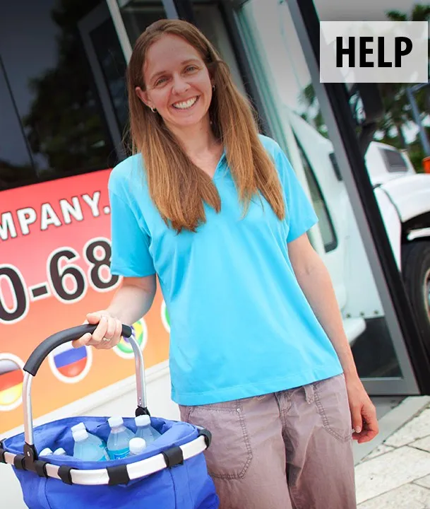 A smiling Michelle Moore offering free water near the bus