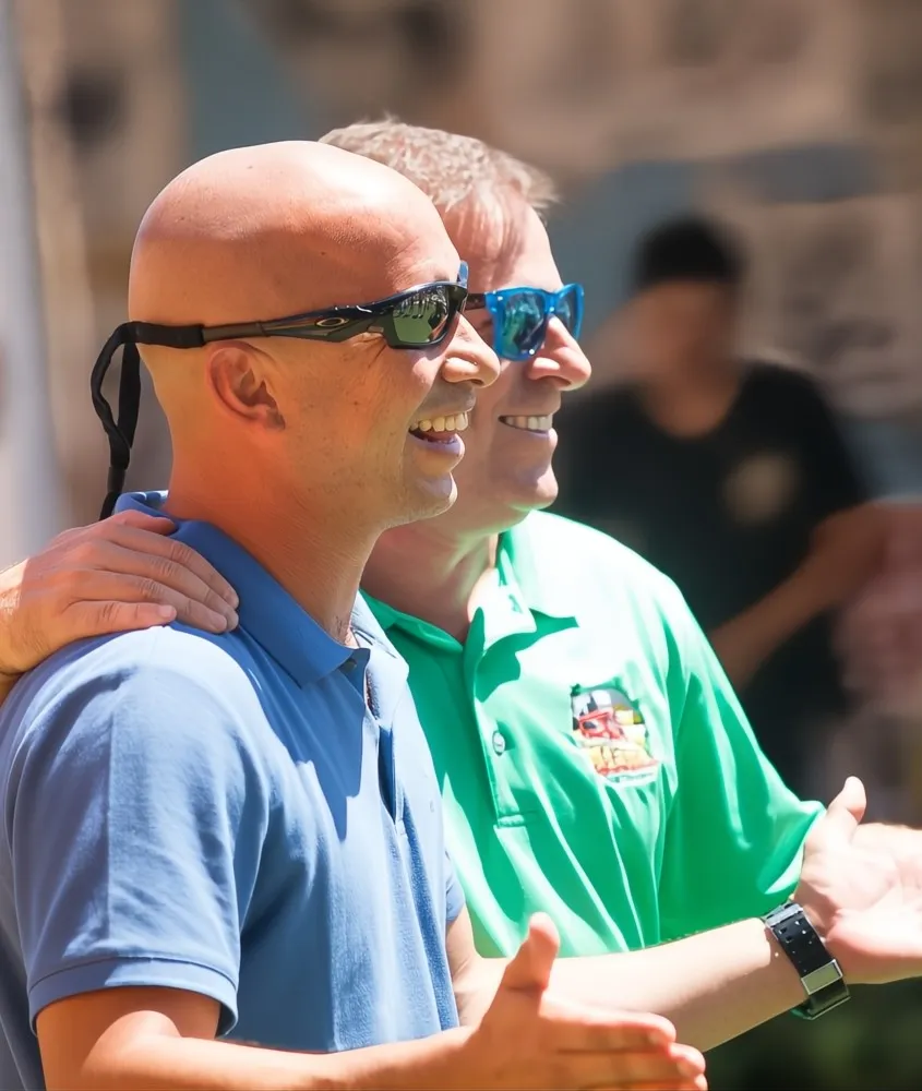 A smiling Gus Moore and a happy customers taking a silly selfie