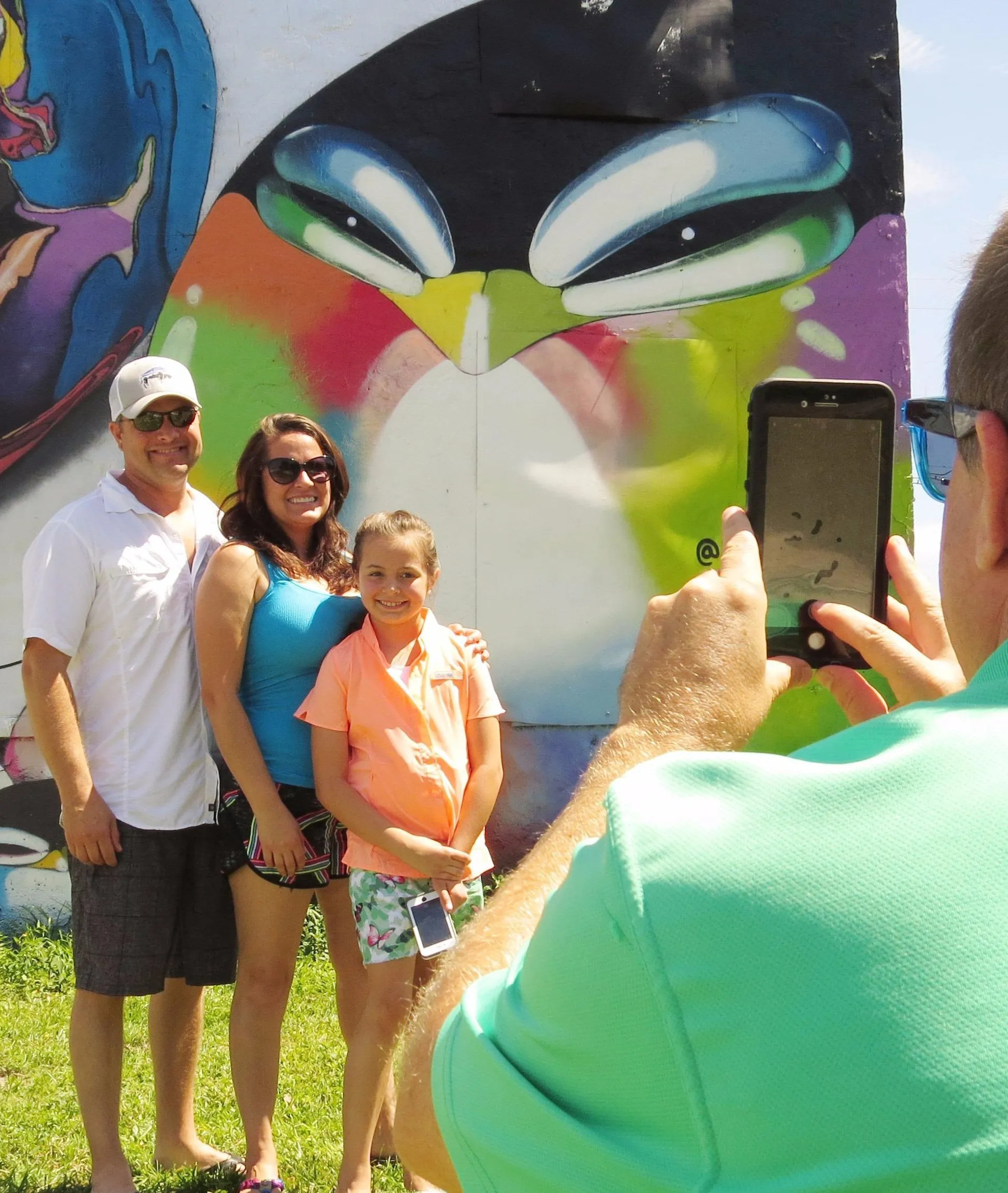 Gus Moore taking a family photo on a sunny day