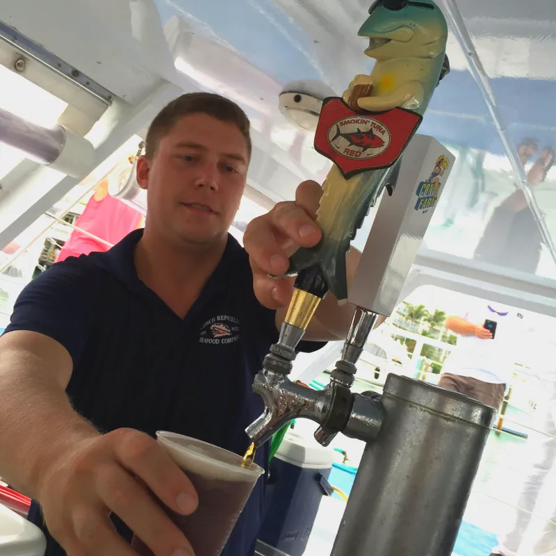 Bartender serving a beer, after the snorkel trip.