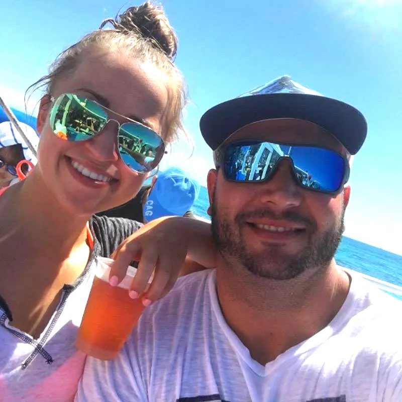 Young man and women in sunglasses partying on the boat.