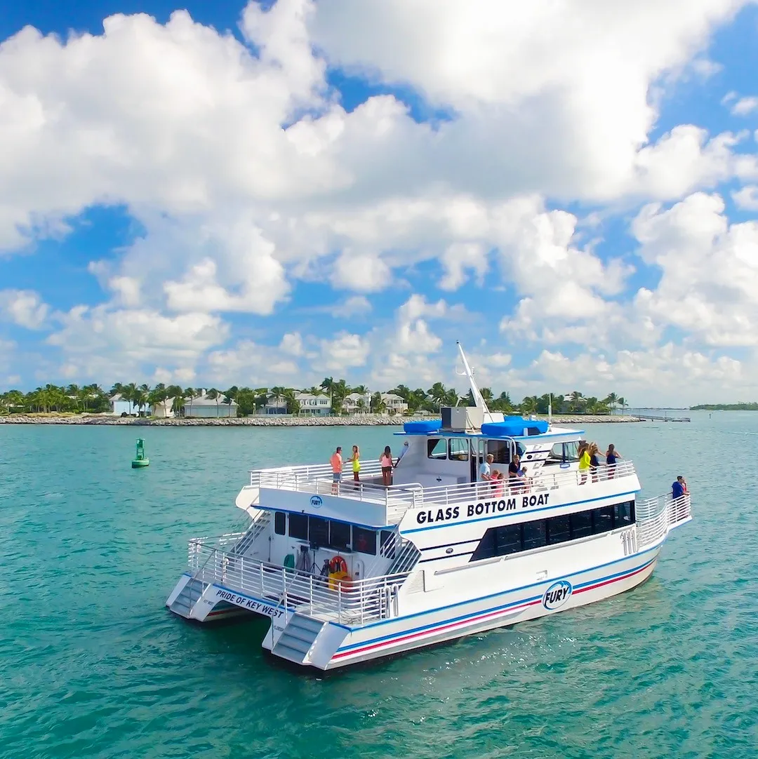 Ariel photo of the glass bottom boat stern, with puffy clouds in the sky.