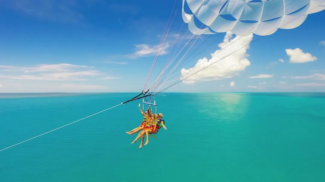 Young couple taking a selfie sailing high above the ocean on a sunny day.