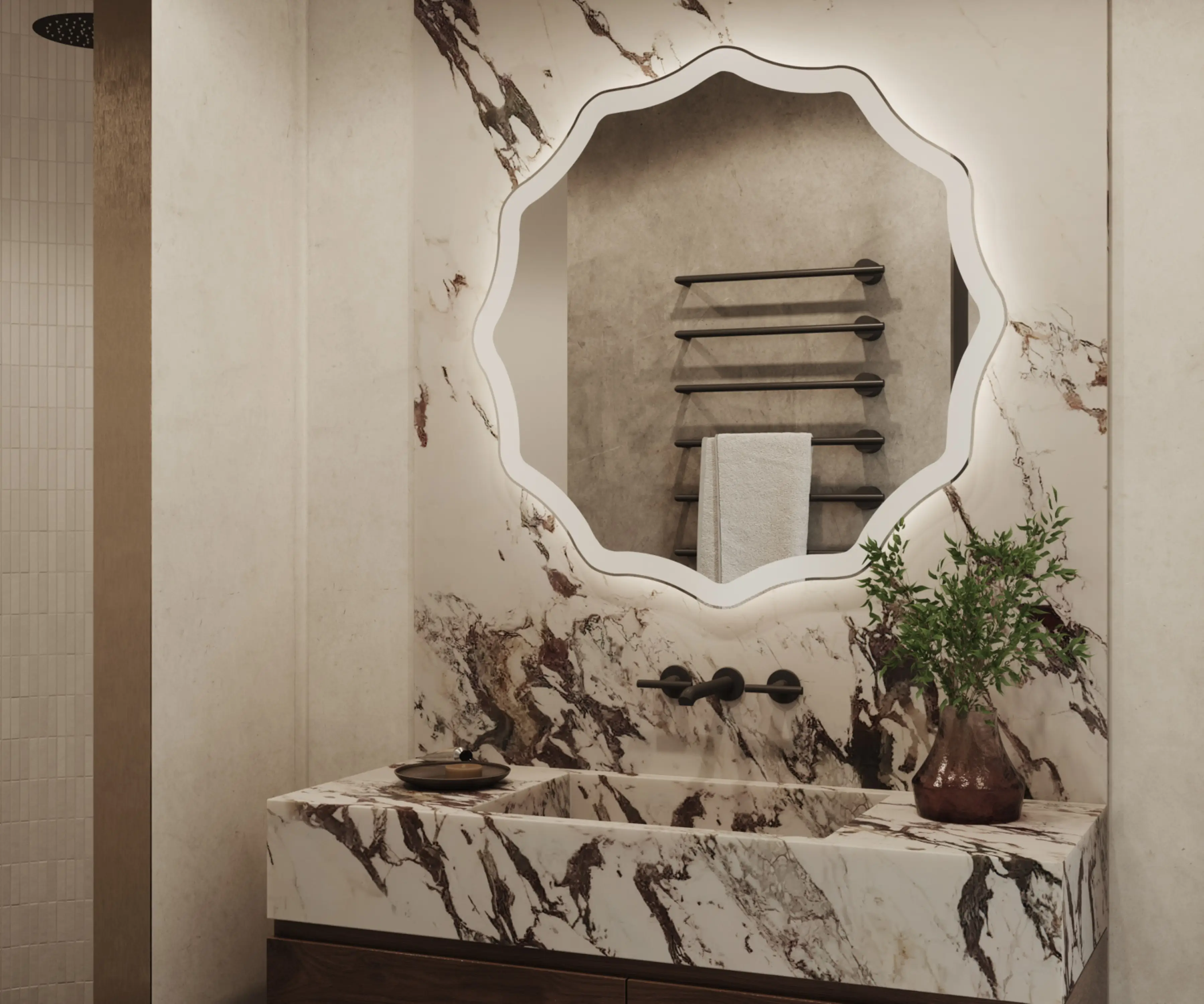 Detal ozdobnego lustra łazienkowego z oświetleniem krawędziowym LED i czarną baterią podtynkową.