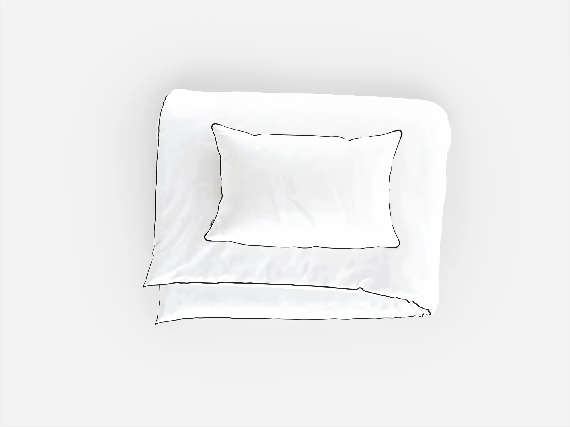 Widok z góry na komplet białej pościeli z czarną lamówką - minimalistyczny design