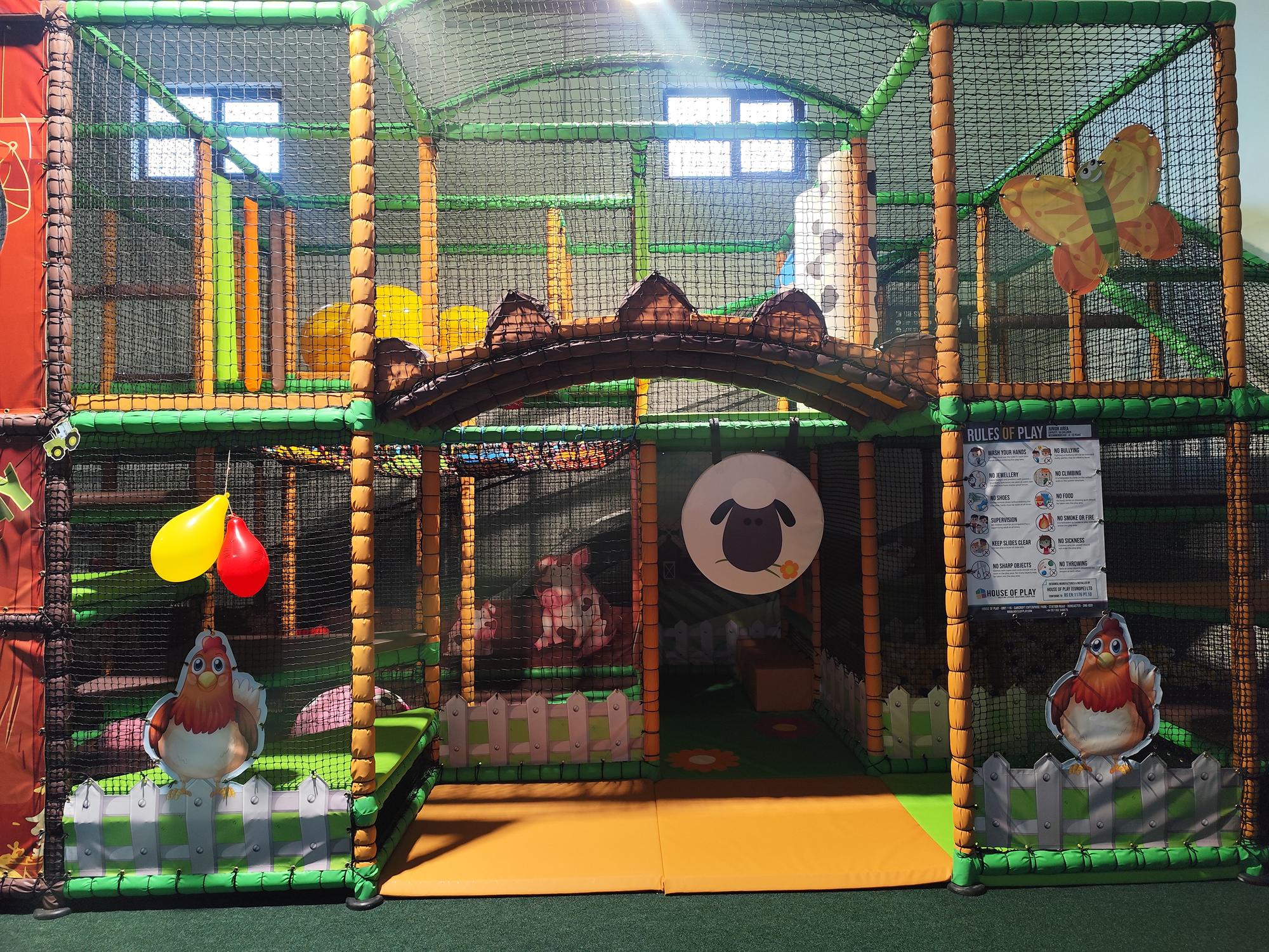 Indoor children’s play area with soft climbing structures.