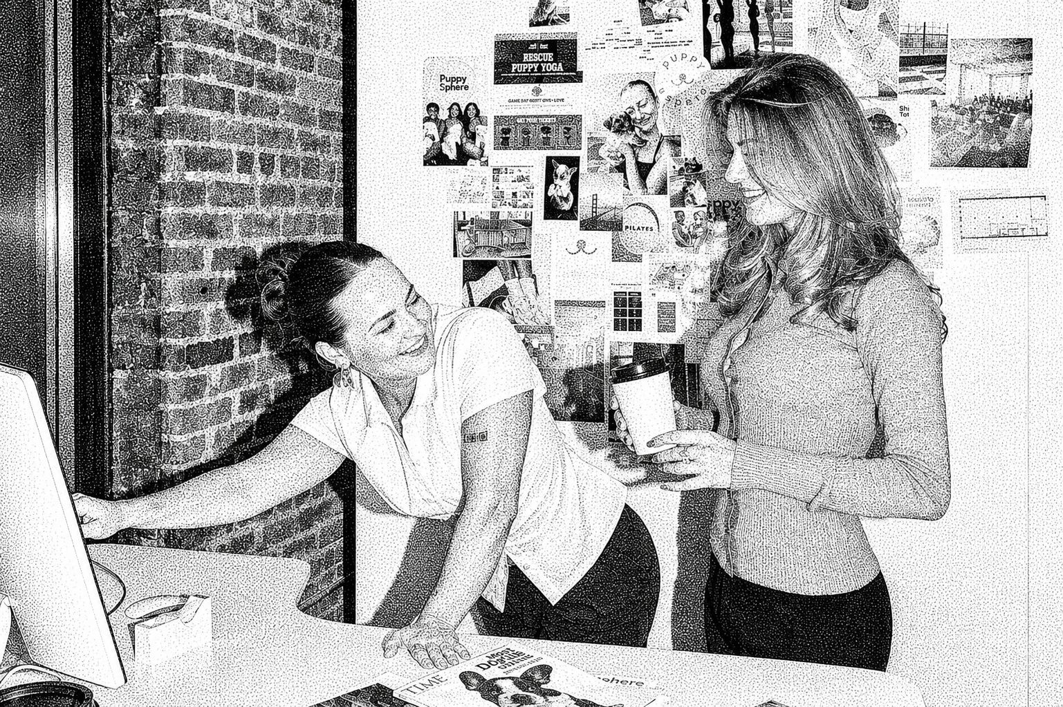 Puppy Sphere team members at a studio front desk beside a wall of press clippings