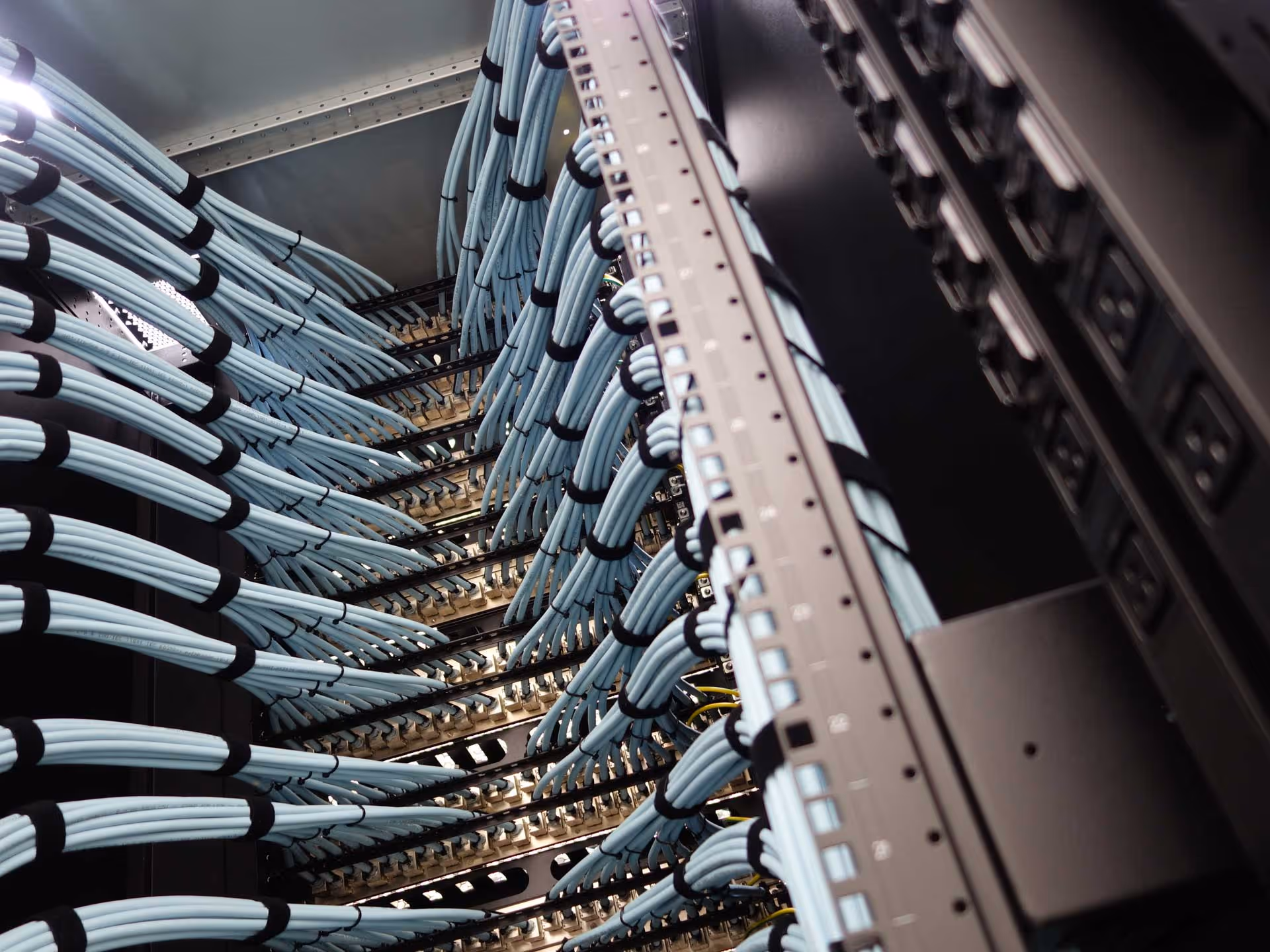 A data center with neatly organized blue cables connected to server racks.