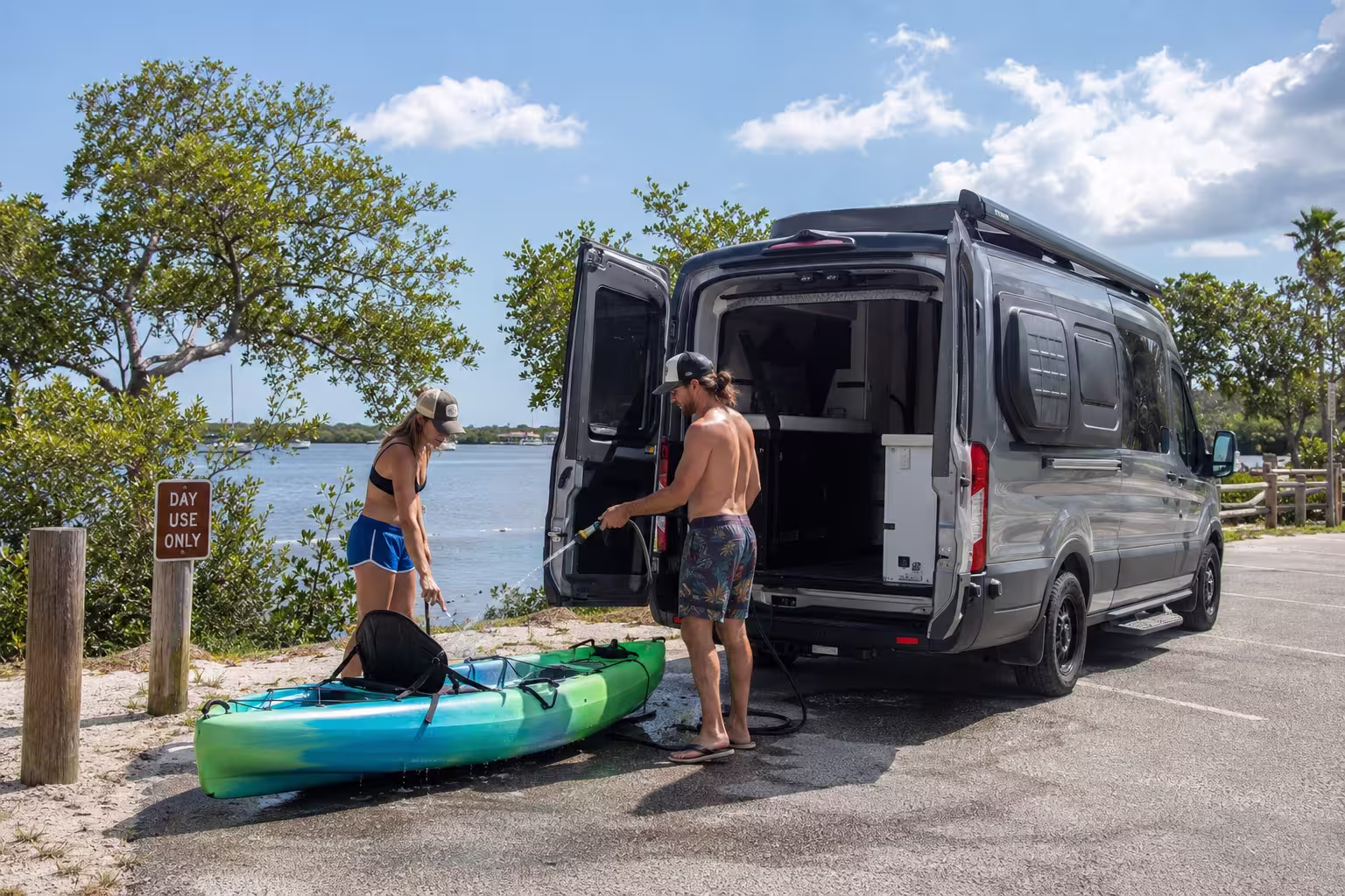 Couple with kayak beside a camper van in Punta Gorda