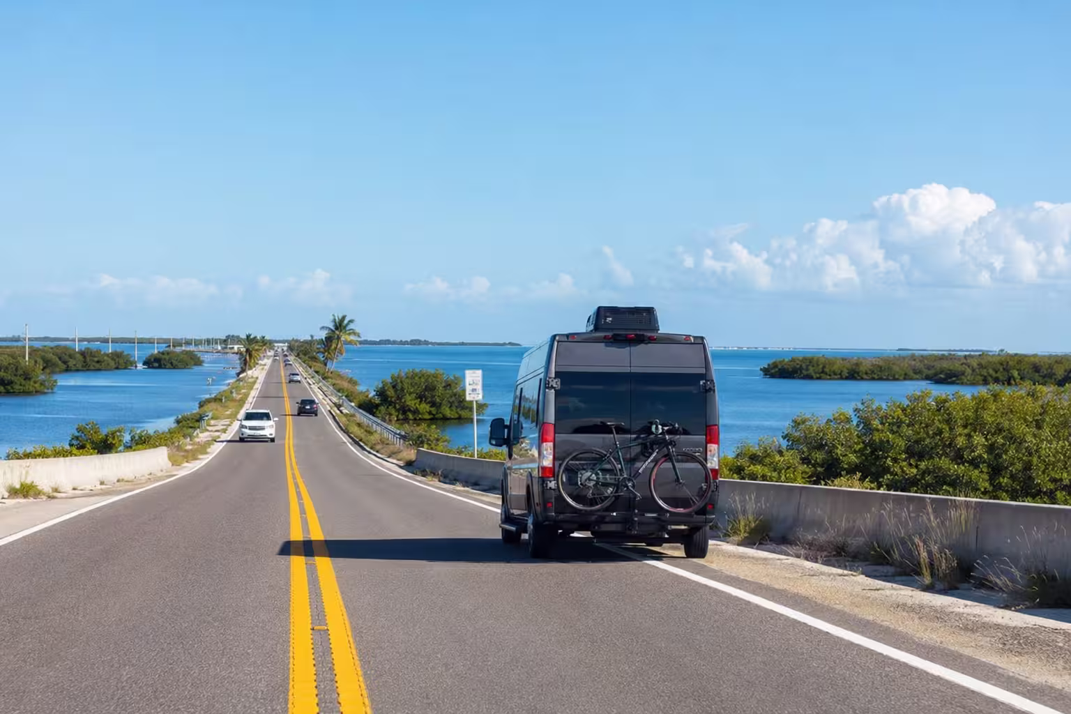 Camper van driving a coastal causeway near Punta Gorda