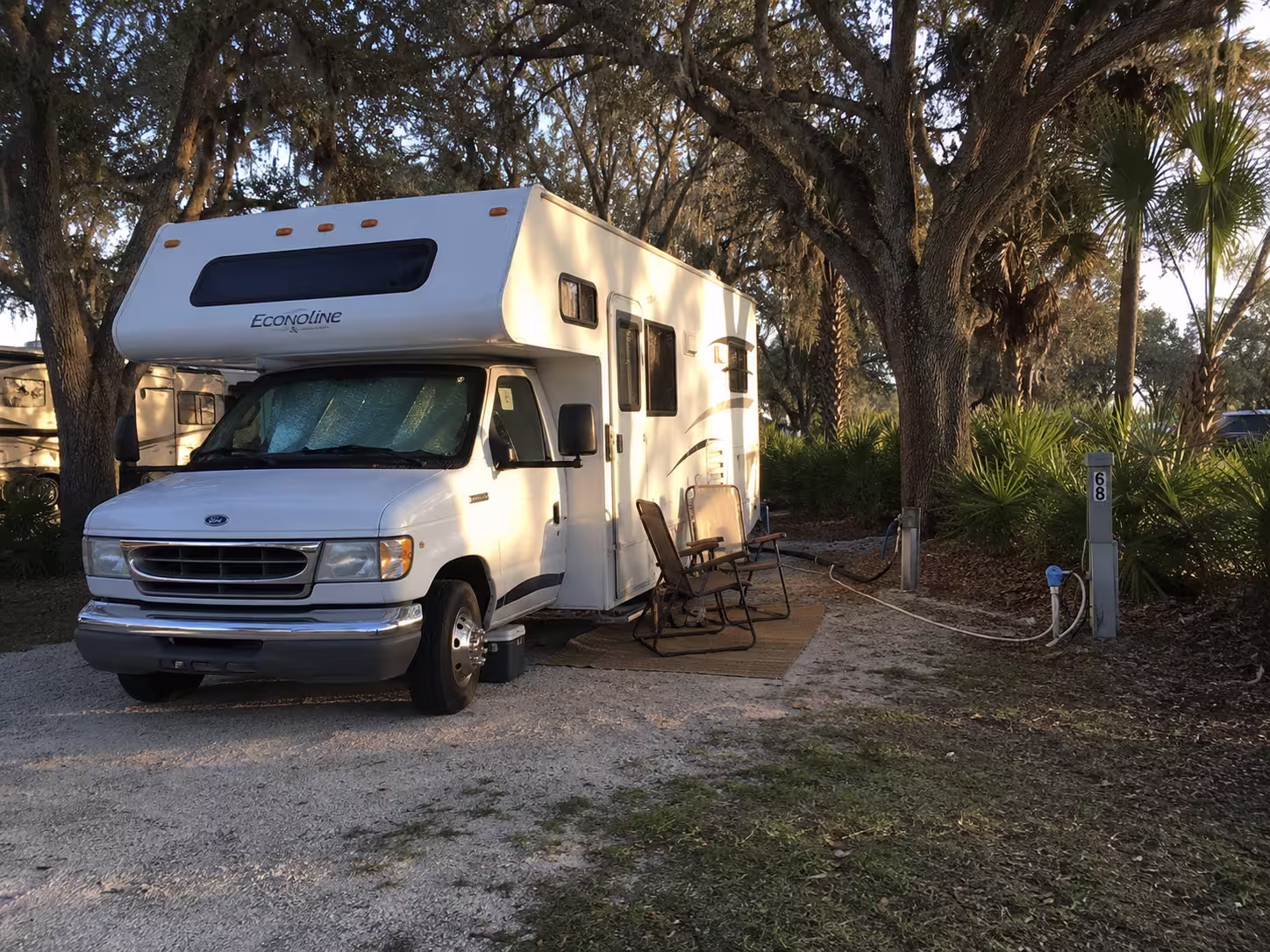 Short Class C motorhome hooked up at a Charlotte County RV park