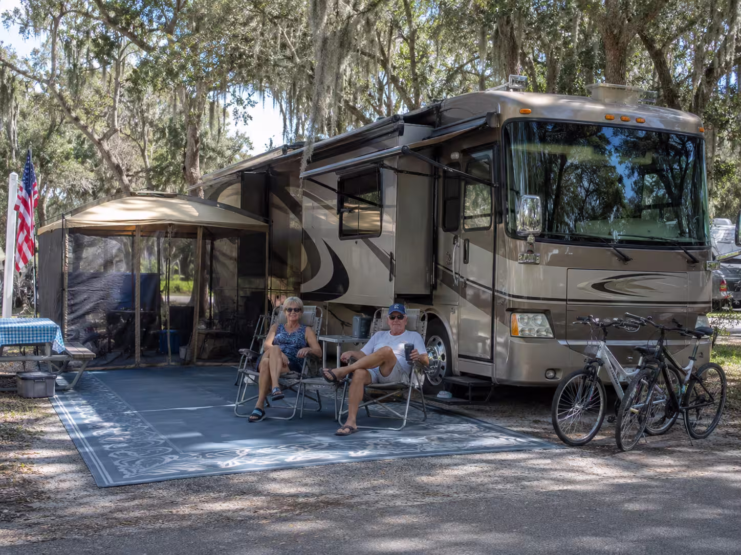 Snowbird couple outside a Class A motorhome near Punta Gorda