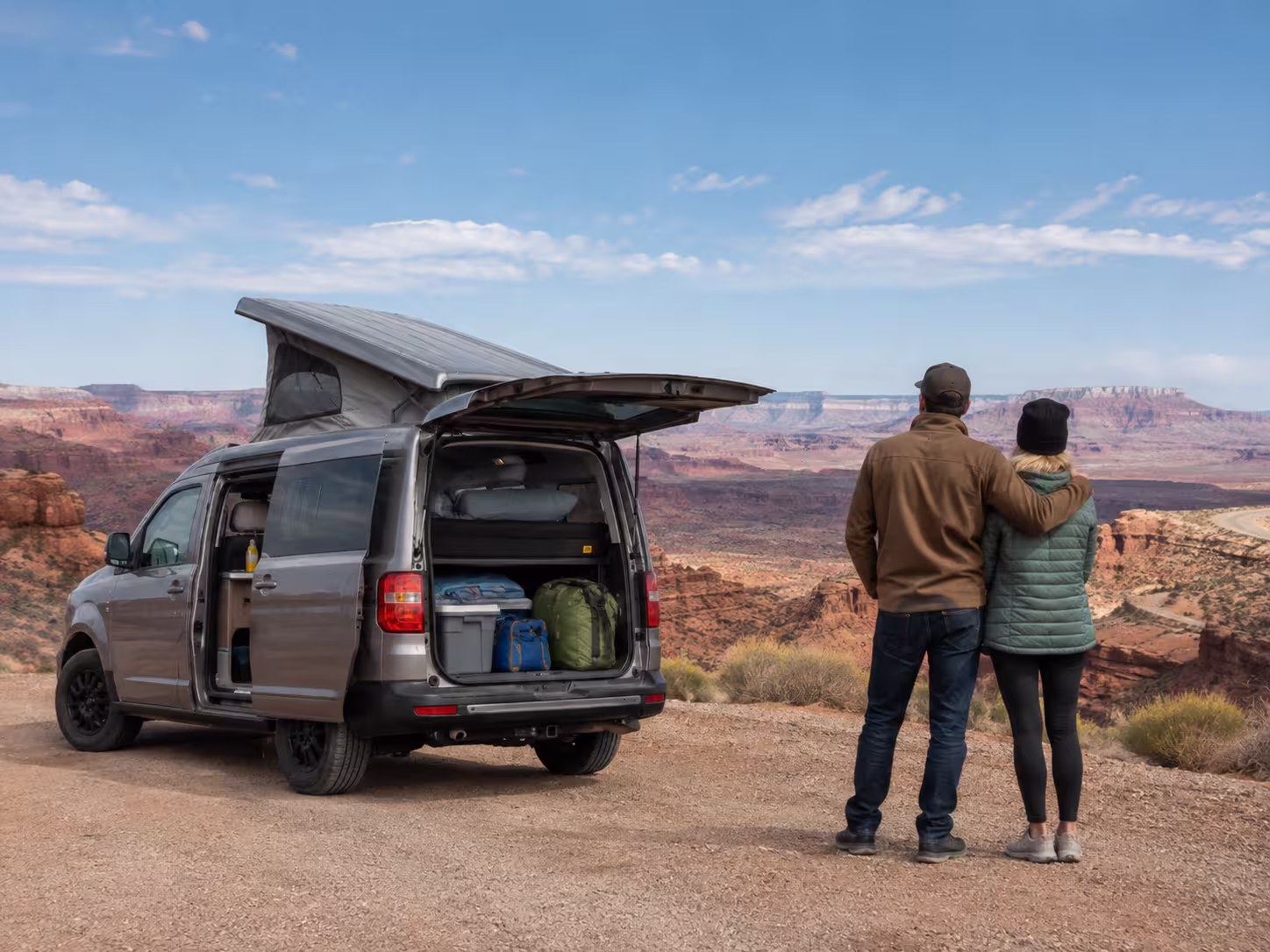 Couple with small camper van rental on a Utah red rock route
