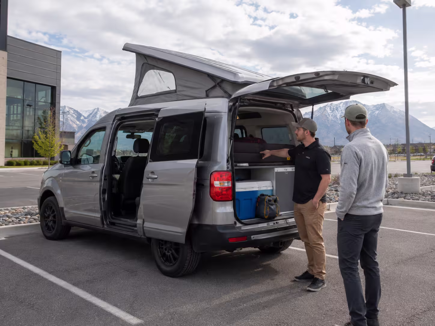Manager showing a small RV rental to a renter in South Jordan, Utah