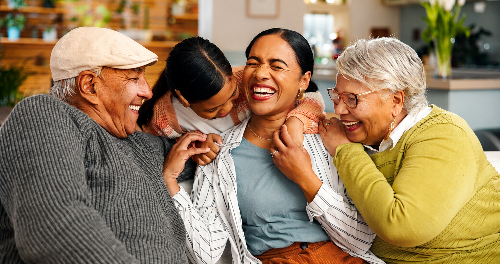 Happy multigenerational family sharing a joyful embrace at home.