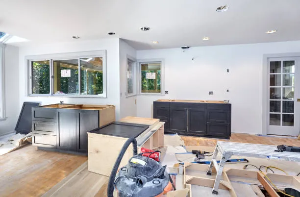 A kitchen under renovation with new cabinets being installed and tools scattered around, demonstrating how an independent insurance agency in South Florida supports homeowners.