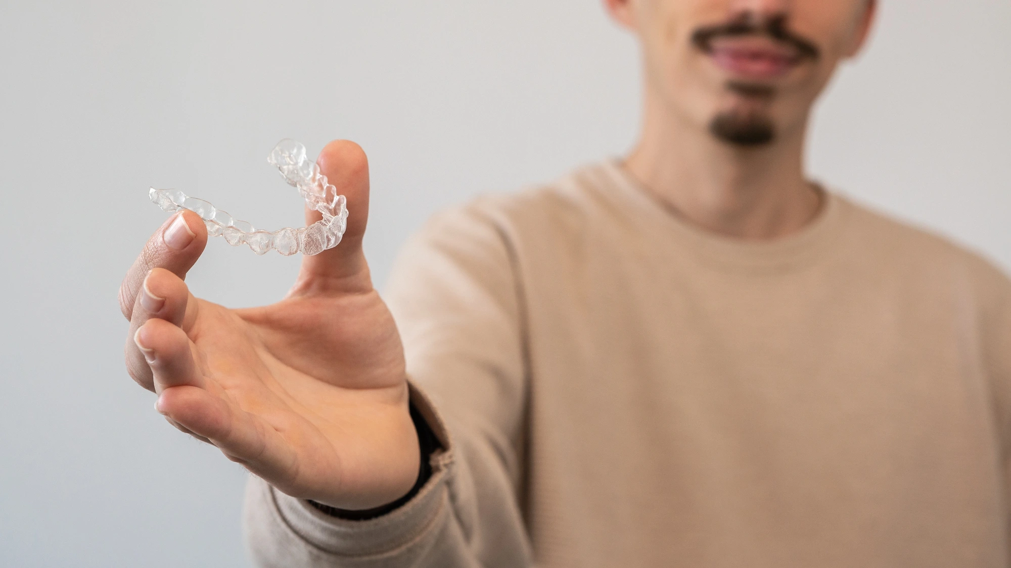 man holding Invisalign in Southfield, MI