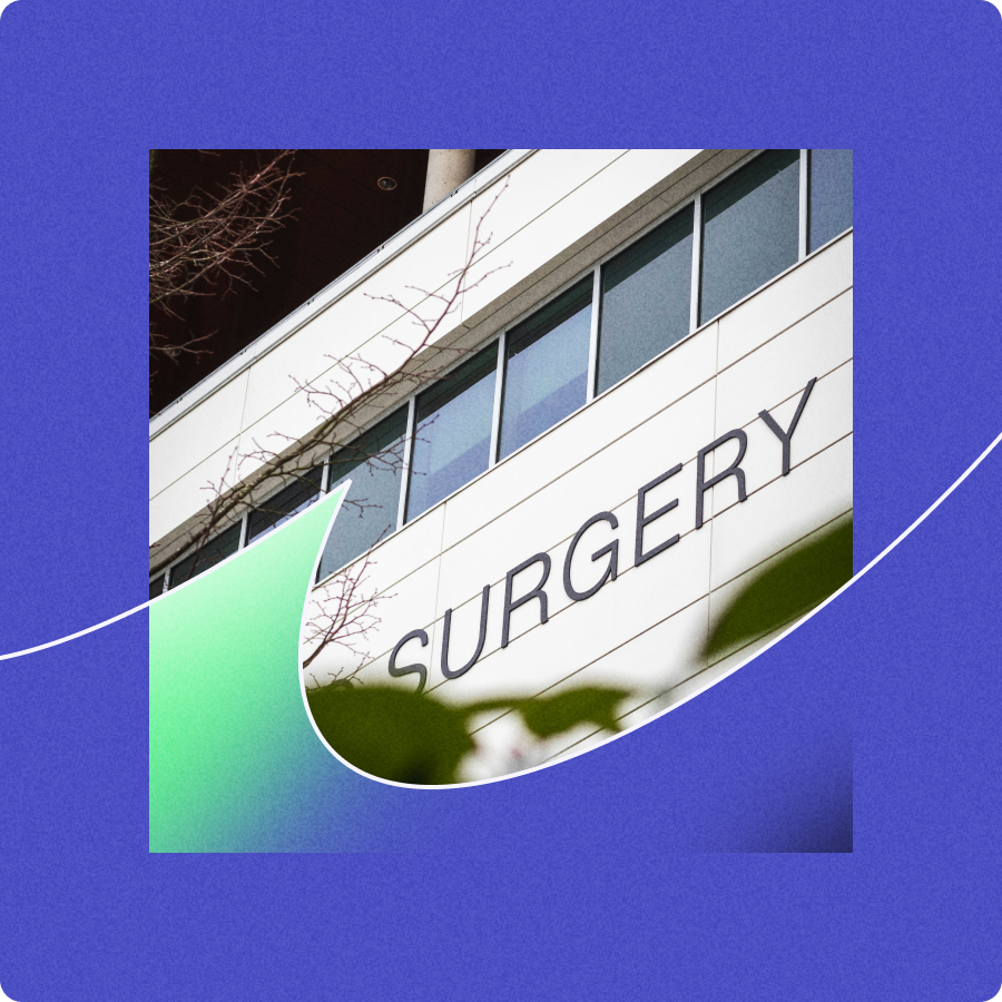 Exterior of a building with large windows and the word 'SURGERY' displayed on the facade.