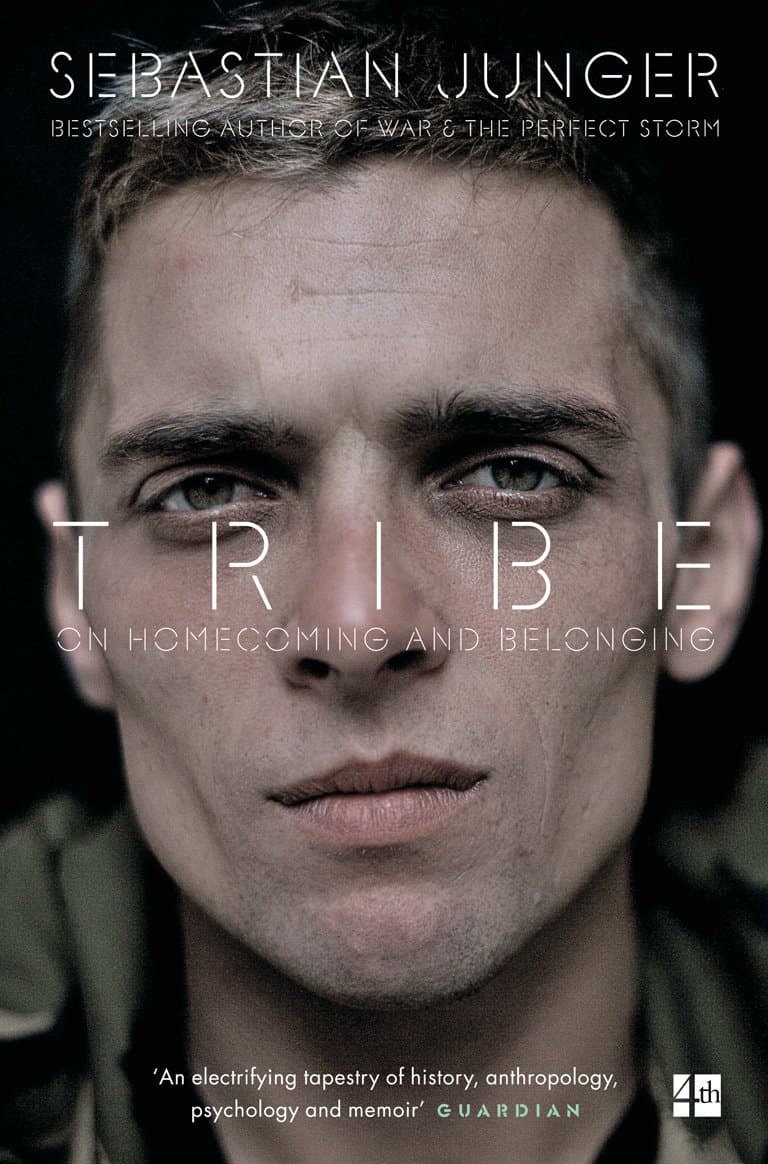 Close-up portrait of a man with short hair looking directly at the camera, overlaid with text for the book 'Tribe: On Homecoming and Belonging' by Sebastian Junger.