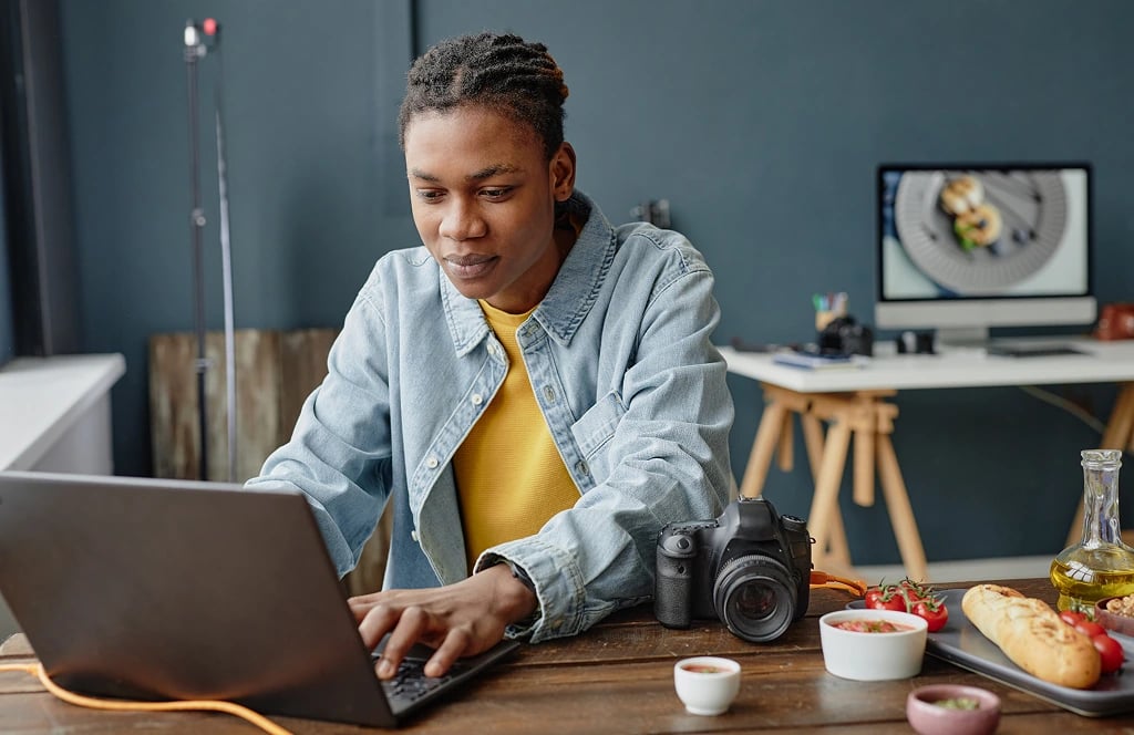 young man on laptop in office room