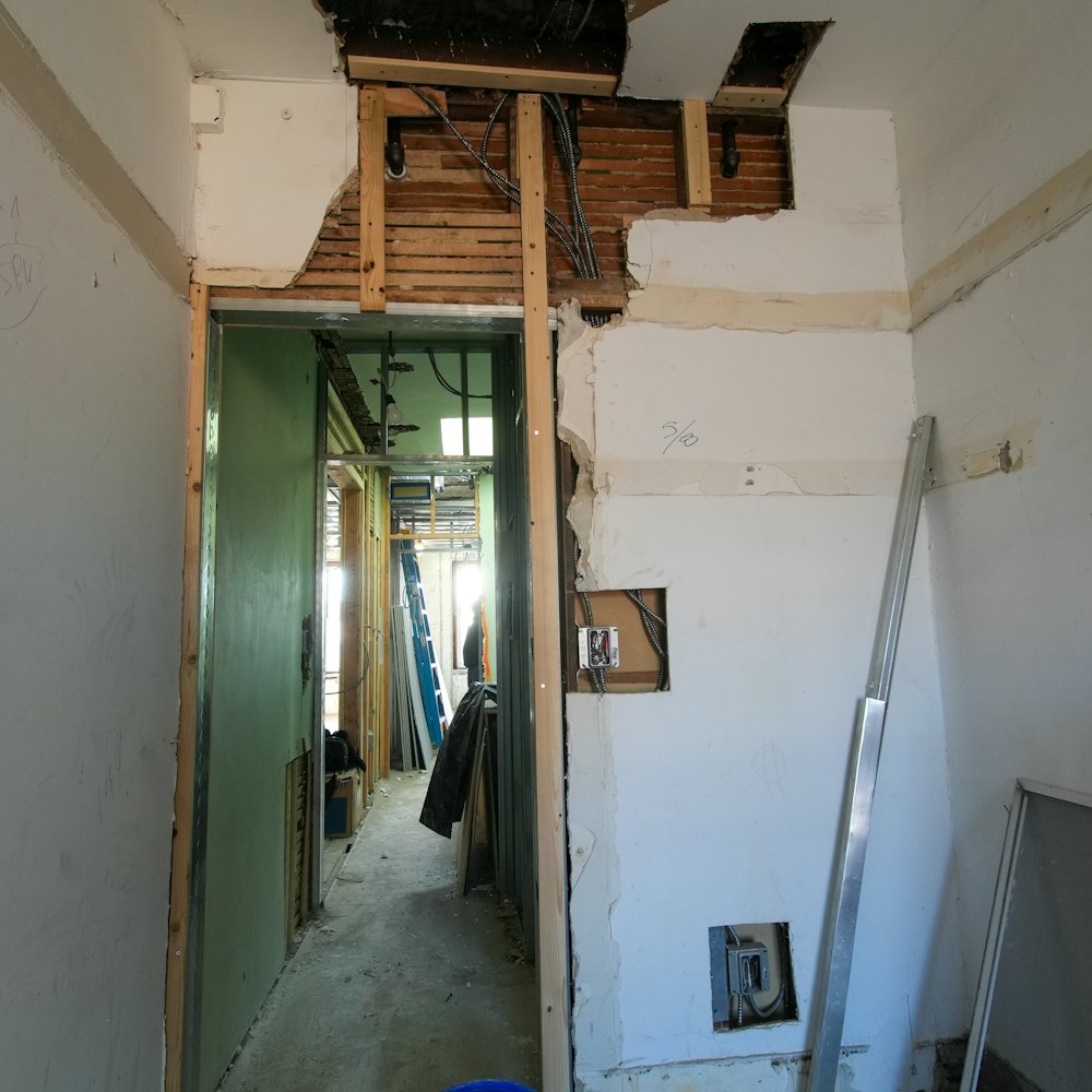 Building interior under renovation with open walls and exposed framing