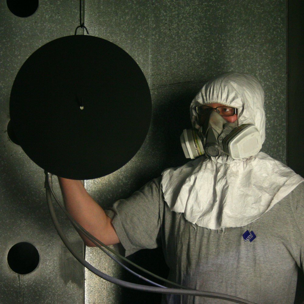Worker in a protective suit and respirator during abatement work