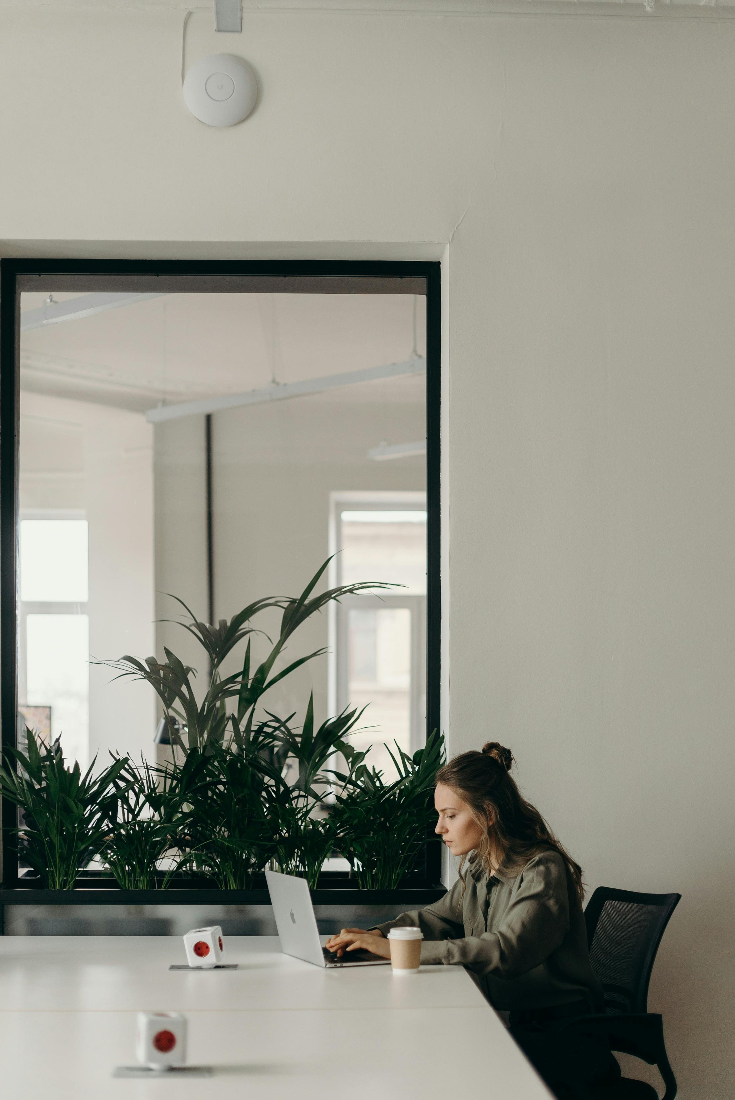 a lady sitting at a desk on a laptop