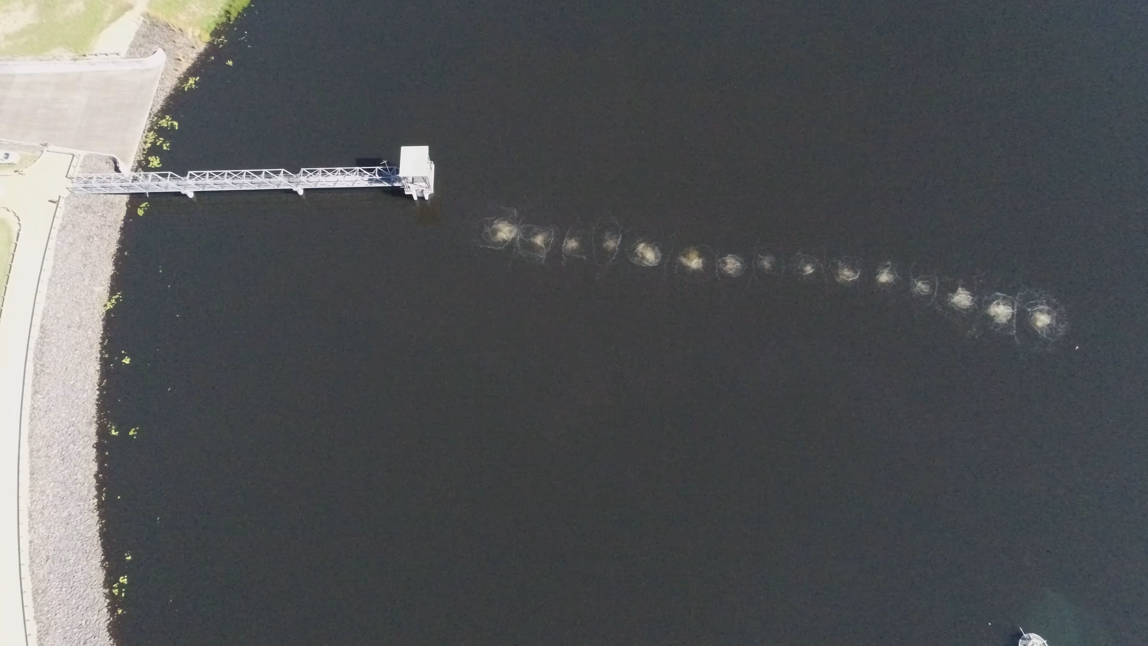 Diffused aeration system installed near the base of a water storage dam to improve water quality.