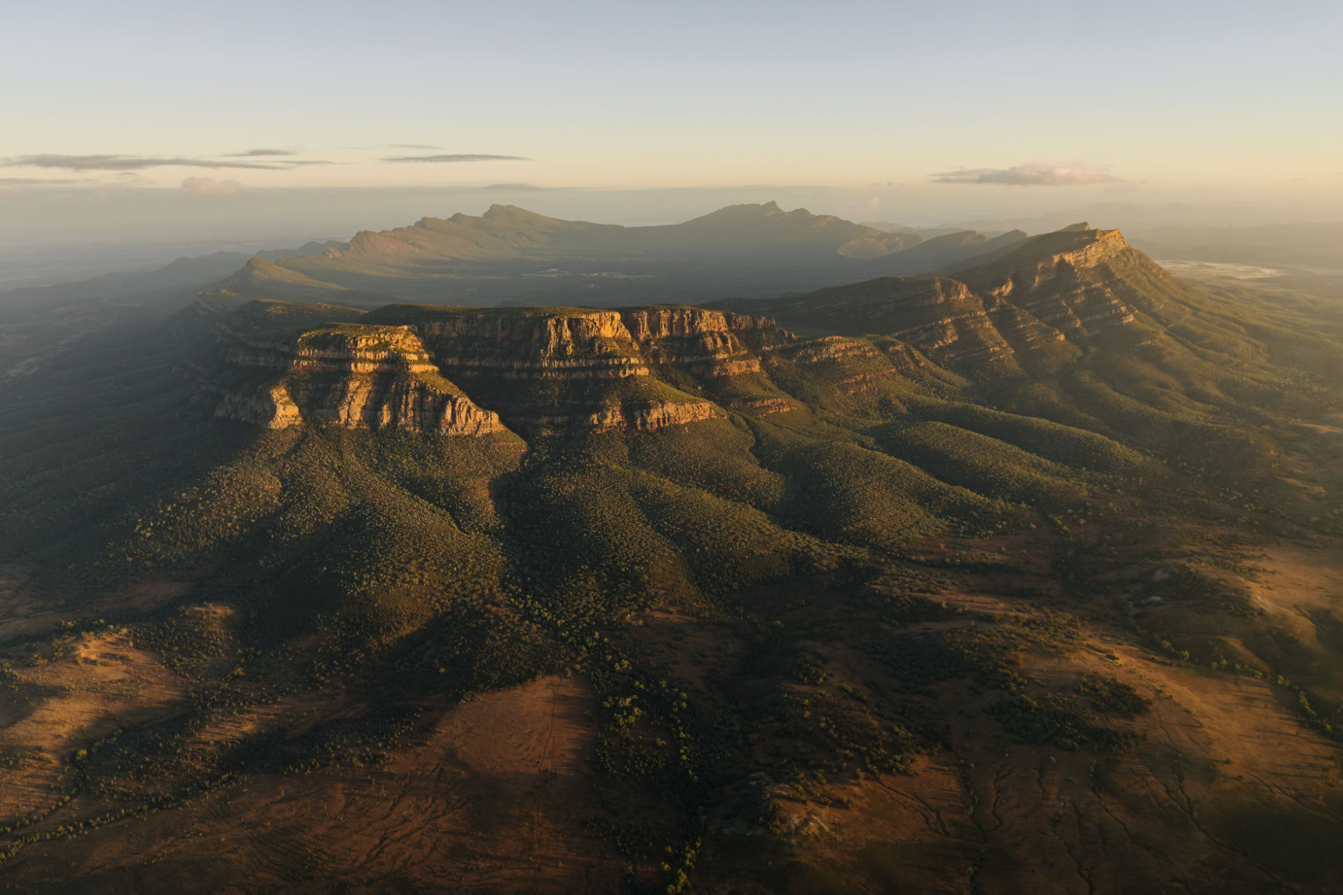 Wilpena Pound in the Flinders Ranges, showing a vast outback landscape with rugged mountain ranges in South Australia’s Far North region.
