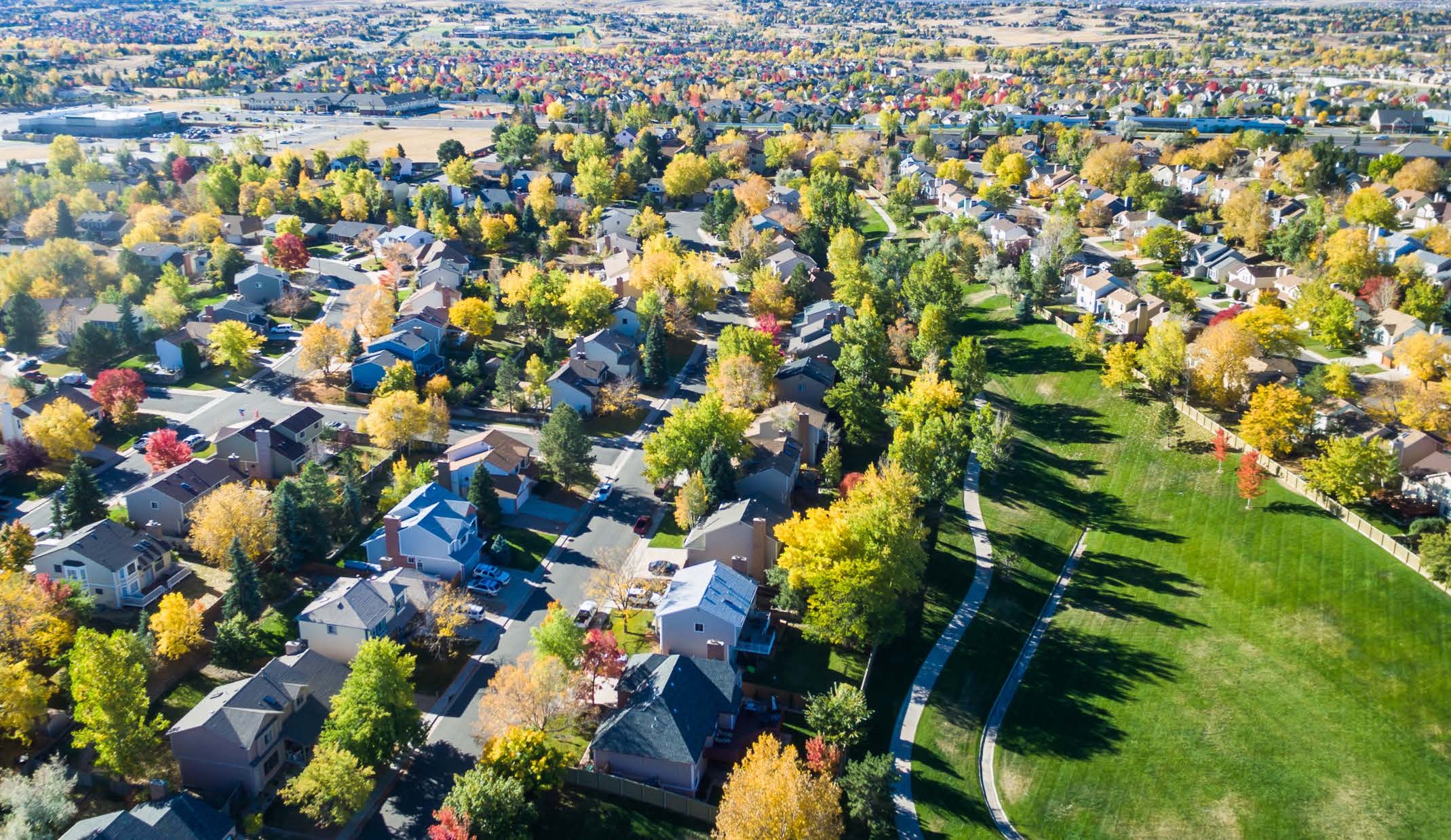 Regional housing aerial view with autumn trees and roads
